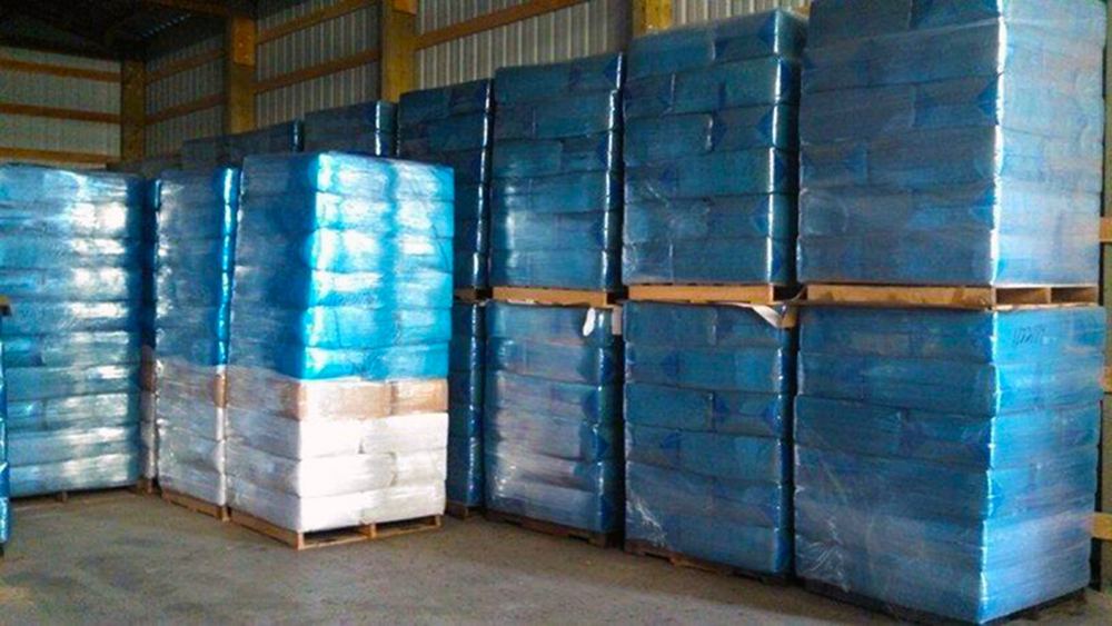 Trucks loaded with wrapped pallets of Easy Pick Shavings